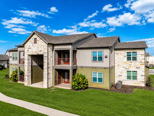 A large two-story house with a stone facade and a garage.