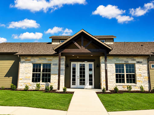 A building with a stone facade and a large glass door.