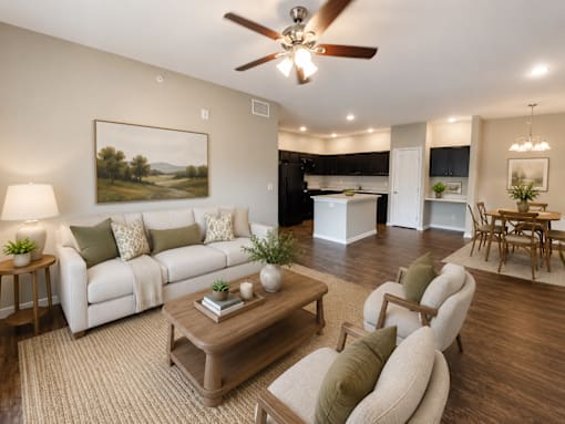A living room with a white couch, a coffee table, and a painting on the wall.