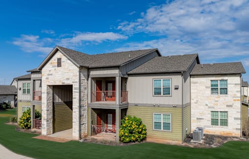A large house with a grey roof and a garage door.