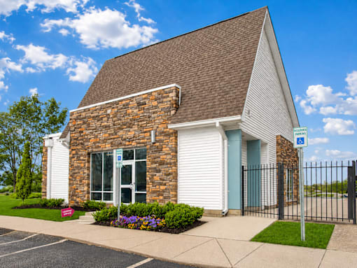 A small church with a parking lot in front.