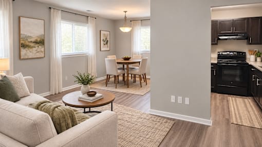 A living room with a couch, a coffee table, and a dining table.