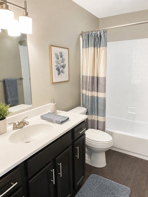 A bathroom with a white sink and a toilet.