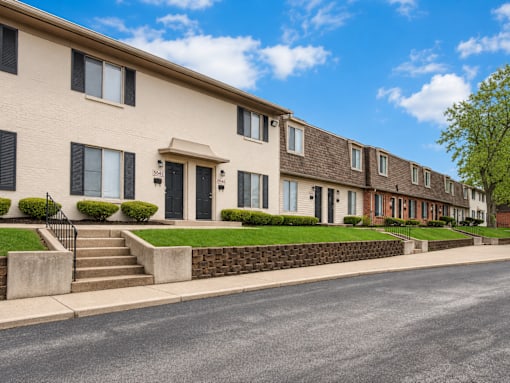 A row of townhouses with a clear blue sky above.