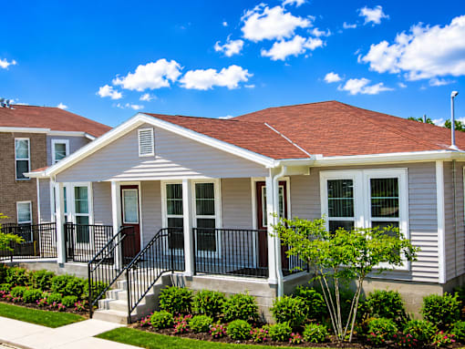 A house with a red roof and a white front porch.