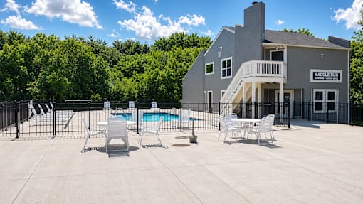 A large building with a pool in front of it.