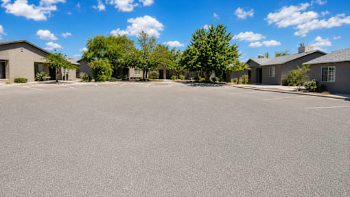A parking lot with a building in the background.