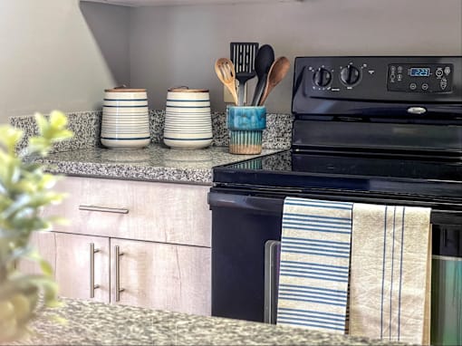 a kitchen with an oven and a counter top with a sink