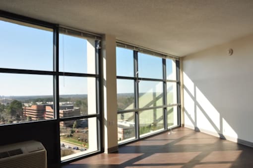 A room with a view of the outside through large windows.