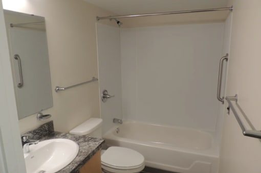 A white toilet sits next to a sink in a small bathroom.