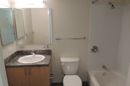 A bathroom with a sink, toilet, and bathtub.