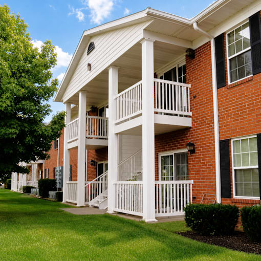 A red brick house with a white porch.