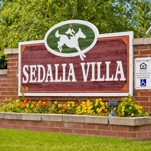 A sign for Sedalia Villa with a horse and rider on it.