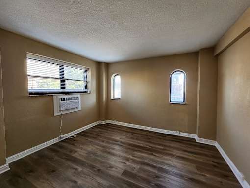 A room with brown walls and wooden flooring.