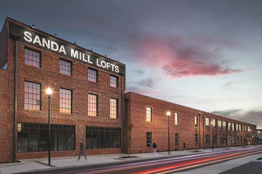 A red brick building with the words "SANDA MILL LOFTS" on the top.