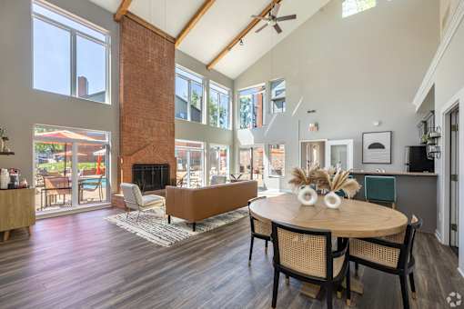 A modern dining room with a wooden table and chairs.