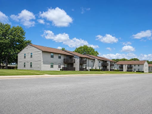 A row of houses with a clear blue sky above them.
