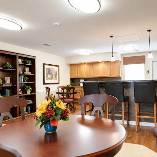 A dining room with a wooden table and chairs.