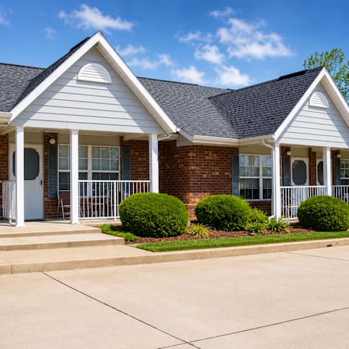 A house with a white front porch and a brick exterior.