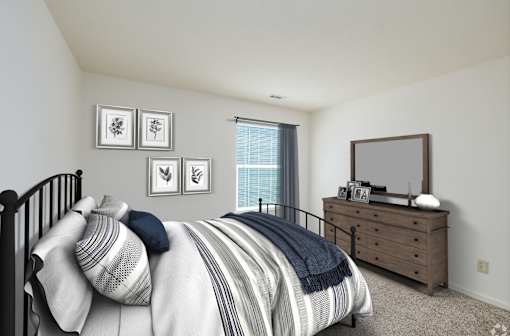A bedroom with a bed, dresser, and mirror.