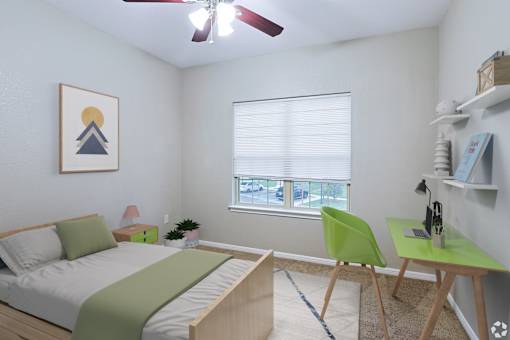 A bedroom with a bed, desk, and chair.