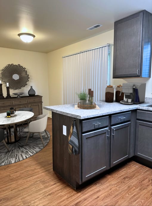 a kitchen with an island and a dining room with a table