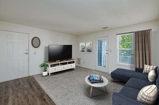 A living room with a flat screen TV and a sofa.