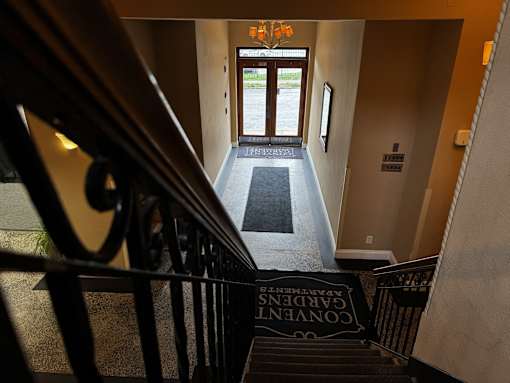 A hallway with a staircase leading to the second floor.