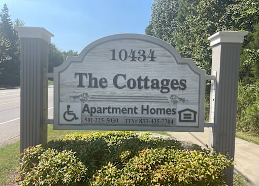 a sign for the cottages apartments and apartment homes