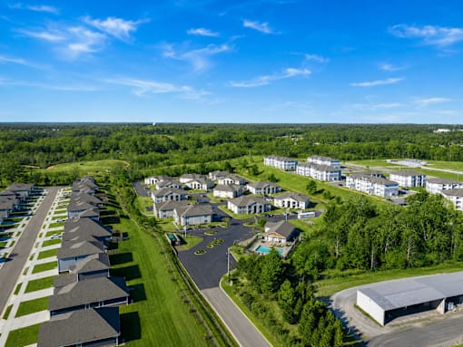 A bird's eye view of a residential area with houses and a large building.