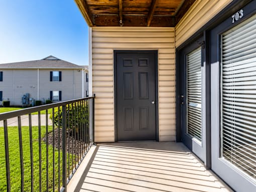 A black door is on the right side of a house.