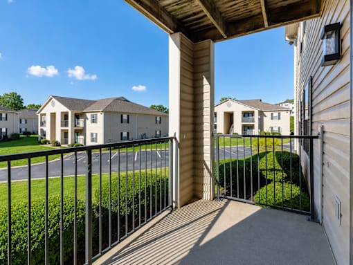 A view from a balcony looking out at a row of houses.