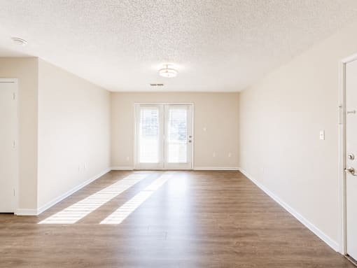 A room with wooden floors and white walls.