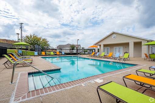 A pool with a yellow and green sun lounger.
