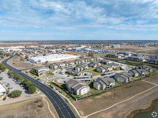 A bird's eye view of a residential area with houses and roads.