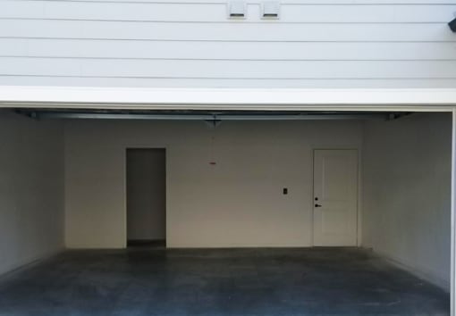 an empty garage in a building with a door