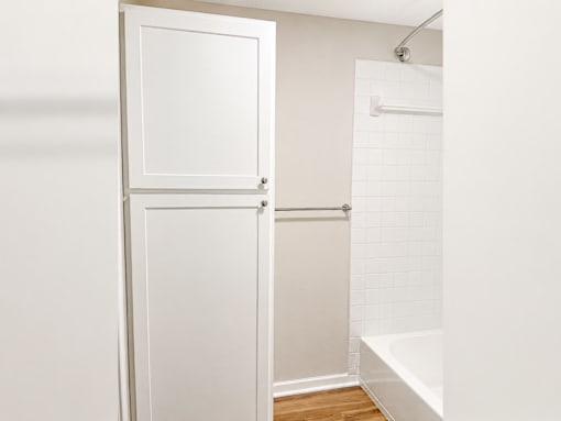 A white door is open to a bathroom.