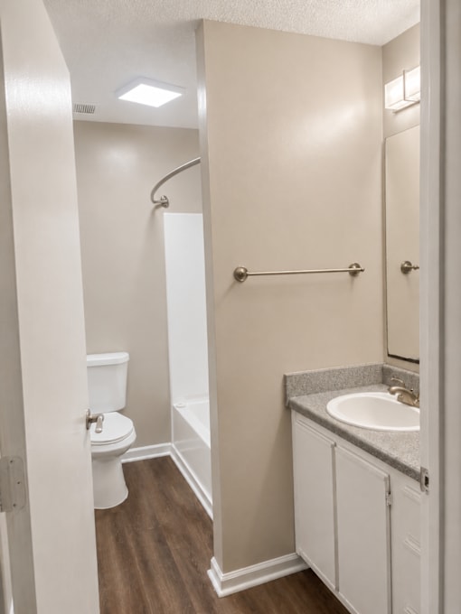 A white toilet is next to a sink in a bathroom.