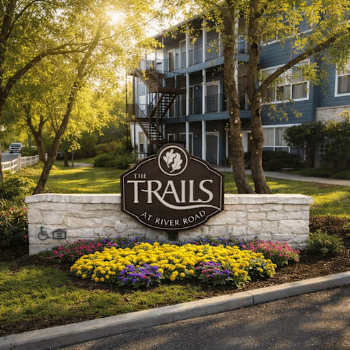 The sign in front of the building says "The Trails at River Road".