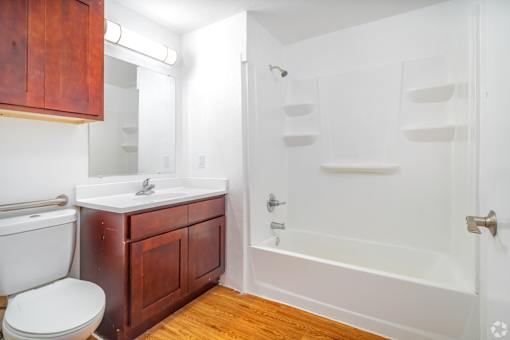 A white toilet sits next to a sink in a bathroom.