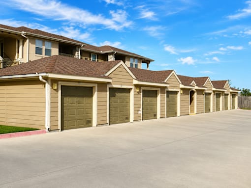 A row of houses with garages in front.
