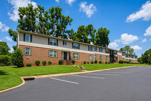 A large building with a parking lot in front of it.