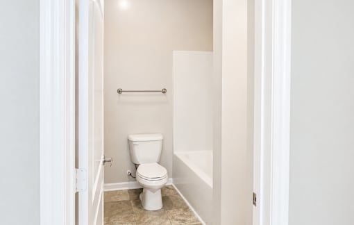 A white toilet in a small bathroom.