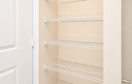 Empty shelves in a white refrigerator.