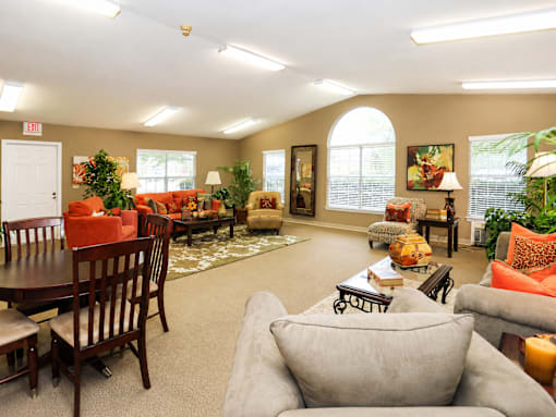 A living room with a grey couch and a wooden table.