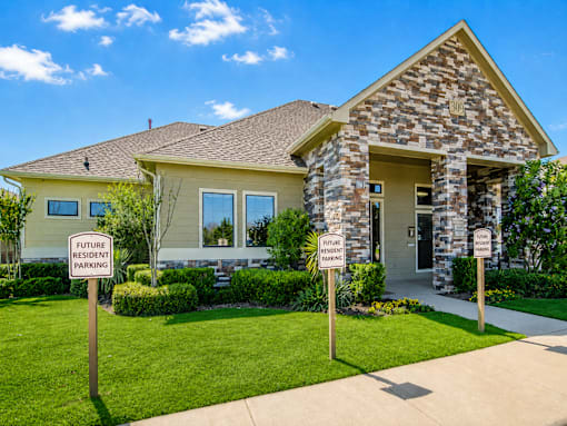 A house with two signs in front that say "Future Resident Parking".