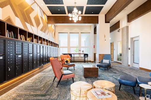 A room with a carpeted floor and a wooden ceiling with a chandelier.