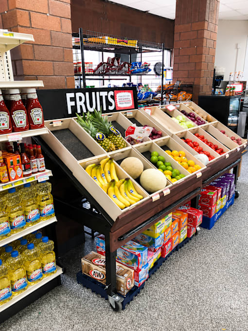 A fruit stand with a variety of fruits and juices.