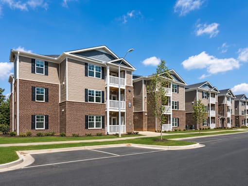 A row of modern apartment buildings with a clear blue sky above.