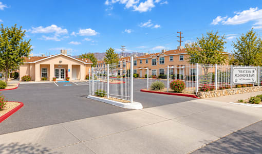 The image shows a sunny day at a gated community entrance with a sign that reads "Winston Pass."